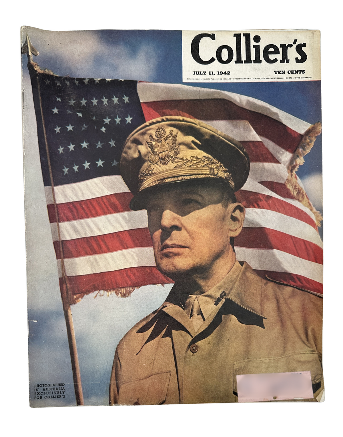 Cover of Collier’s Magazine from July 11, 1942 featuring General Douglas MacArthur in military attire with an American flag backdrop. This historic magazine showcases the prominent figure from World War II.