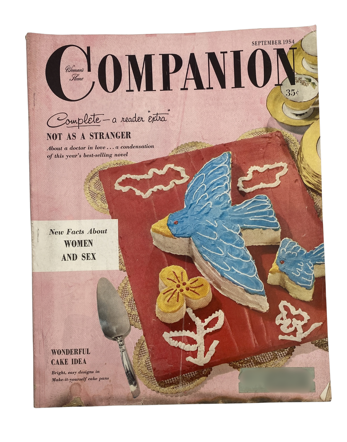Woman’s Home Companion Magazine September 1954 featuring the cover art for 'Not As a Stranger' with vibrant visuals of a blue bird and flowers, showcasing themes of love and sex.