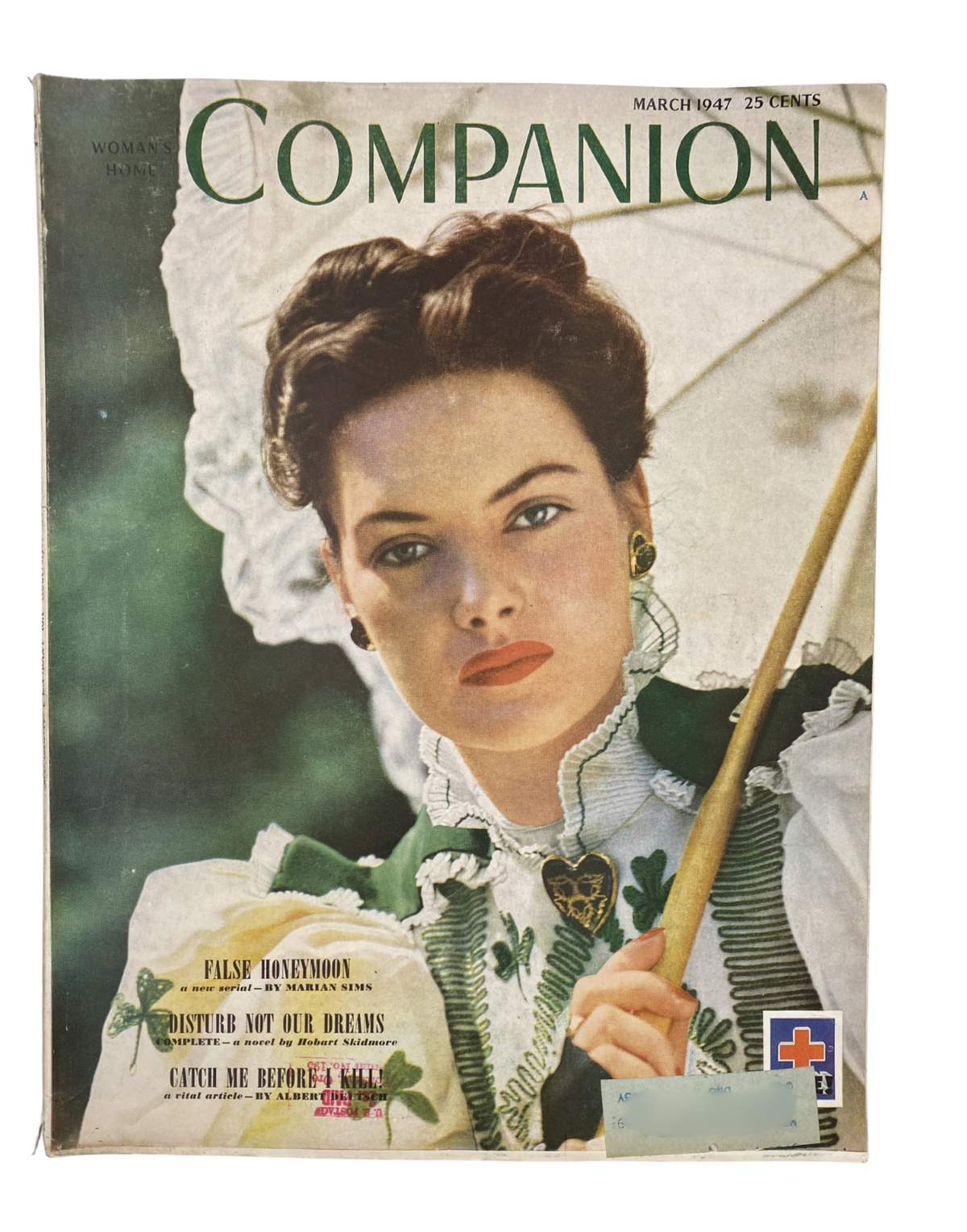 Cover of Woman’s Home Companion Magazine March 1947 featuring a model in a vintage dress, holding an umbrella, surrounded by text highlights including 'Disturb Not Our Dreams' and 'Catch Me Before I Kill!'