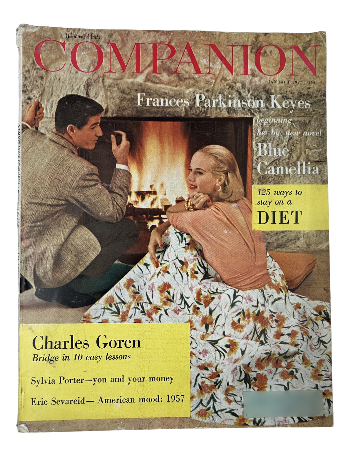 Cover of Woman’s Home Companion Magazine January 1957 featuring the title Blue Camellia by Frances Parkinson Keyes, illustration of a couple by a fireplace, highlighted articles on diet and Charles Goren's bridge lessons.
