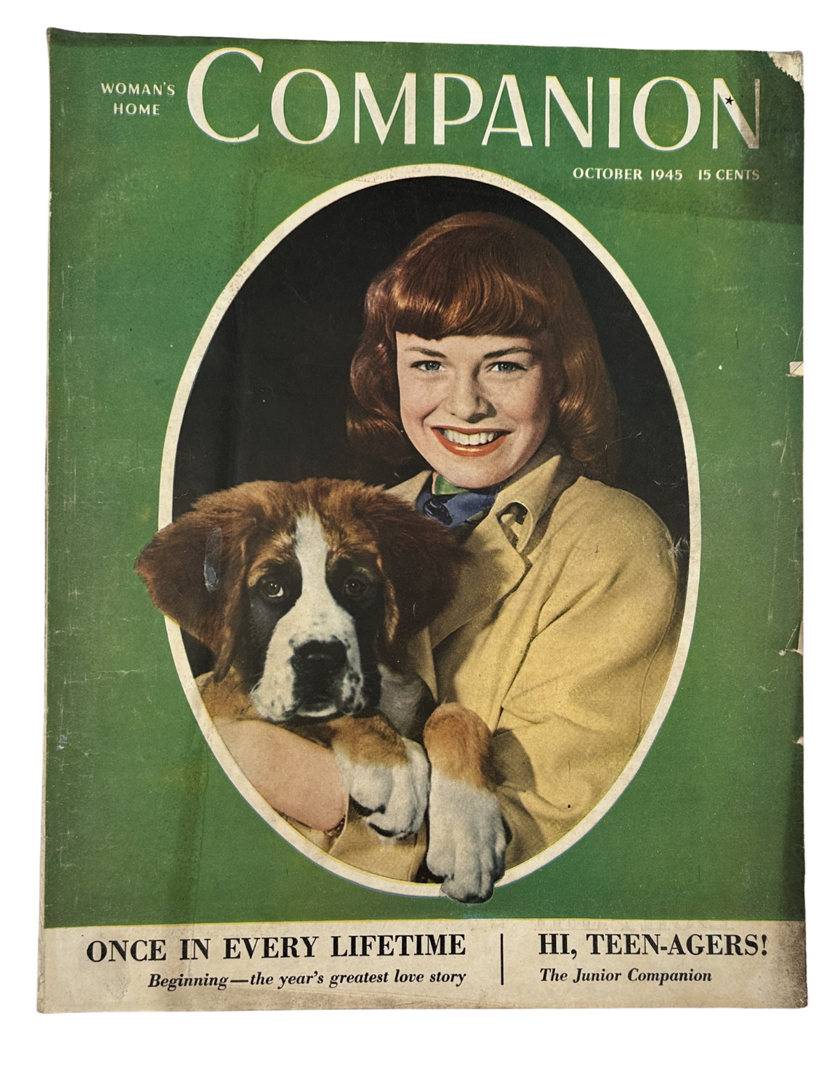 Cover of Woman's Home Companion Magazine October 1945 featuring a young woman with red hair smiling, holding a St. Bernard puppy, with the tagline 'Once in Every Lifetime' and 'Hi, Teen-Agers!'