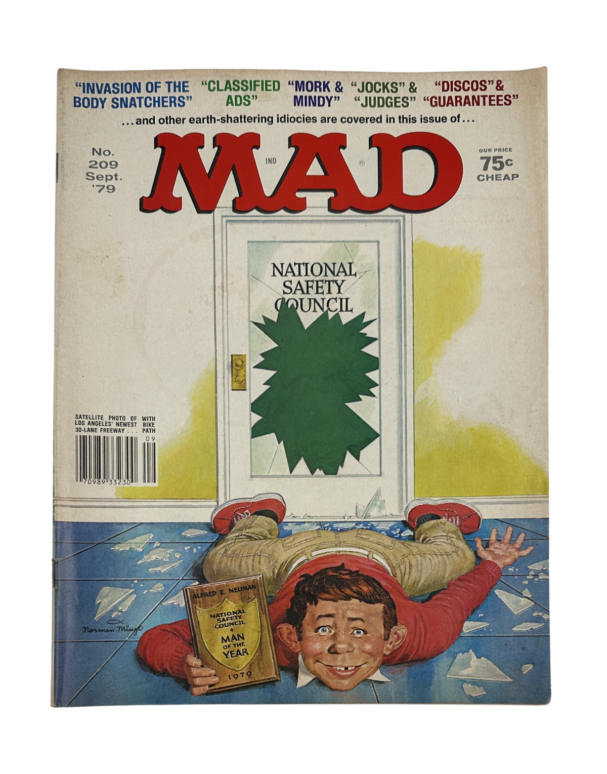 MAD Magazine No. 209 September 1979 cover featuring an illustrated boy lying on the floor with a book, humorously interacting with a door covered by a green splatter, referencing 'Invasion of the Body Snatchers'.