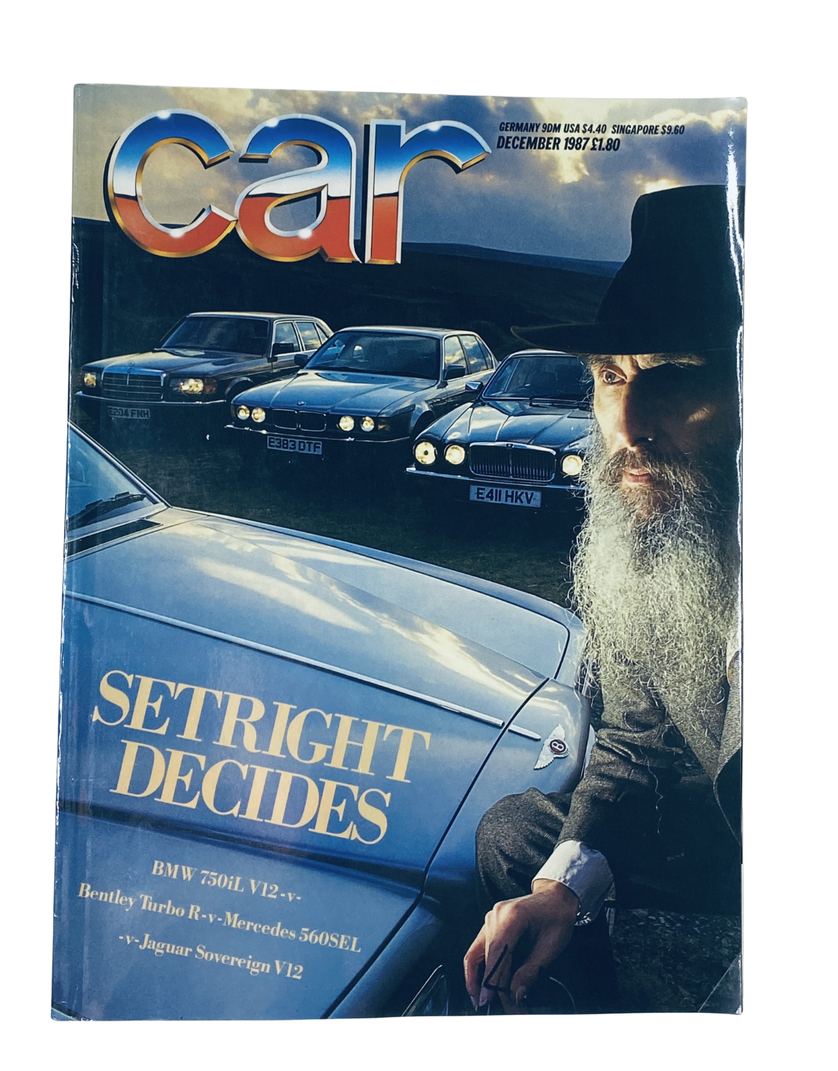 Cover of Car Magazine from December 1987 featuring the title 'Setright Decides BMW 750iL V12, Bentley Turbo R, Mercedes 560SEL, and Jaguar Sovereign V12'. The image shows a man with a beard in front of a BMW 750iL surrounded by luxury cars.