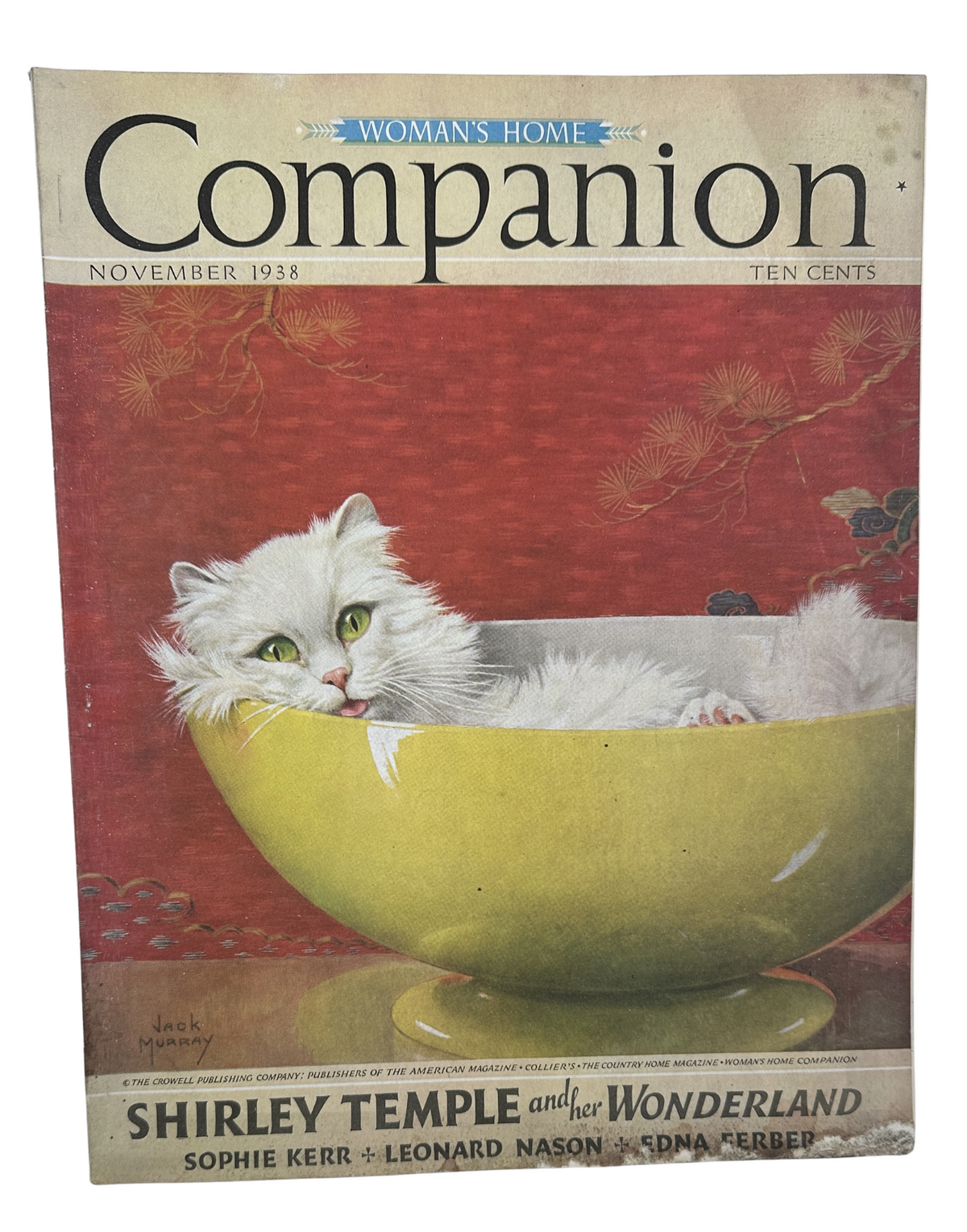 Cover of Woman’s Home Companion Magazine, November 1938, featuring a whimsical illustration of a cat in a yellow bowl, highlighting the theme 'Shirley Temple and her Wonderland'.