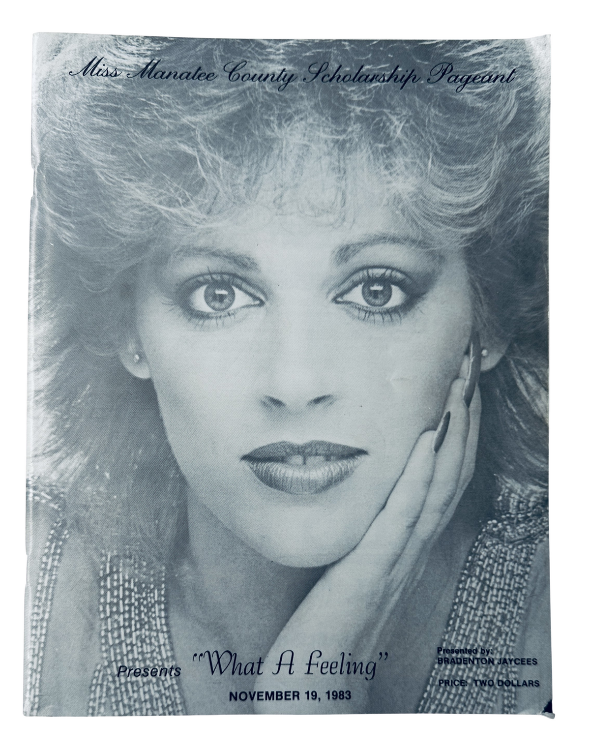 Cover of the 'Miss Manatee County Scholarship Pageant' magazine from November 19, 1983, featuring a black and white portrait of a woman with curly hair and makeup, captioned with 'What A Feeling'.