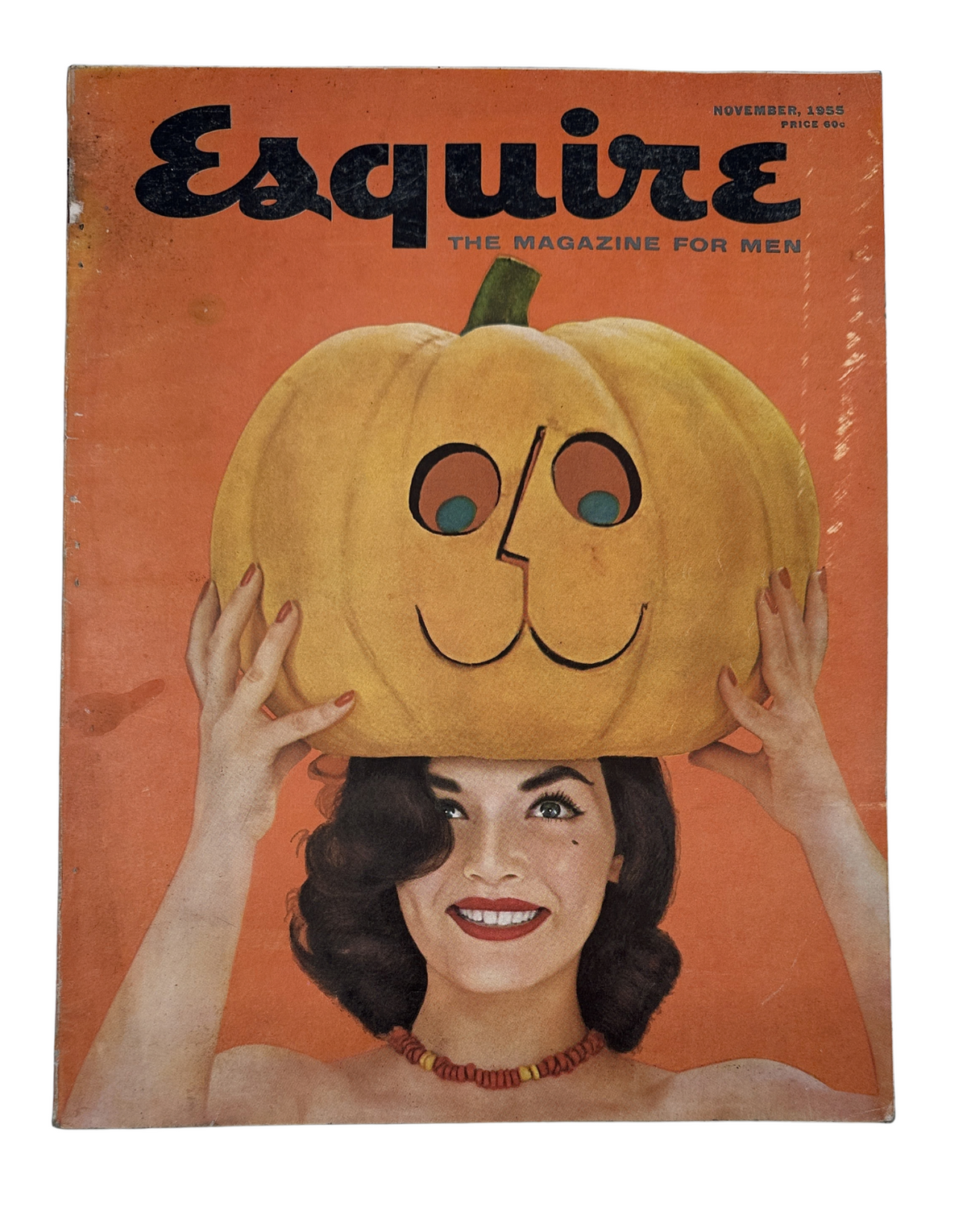 Esquire Magazine November 1955 cover featuring a woman with a pumpkin on her head, designed by George Petty, showcasing the playful and festive theme of the issue.