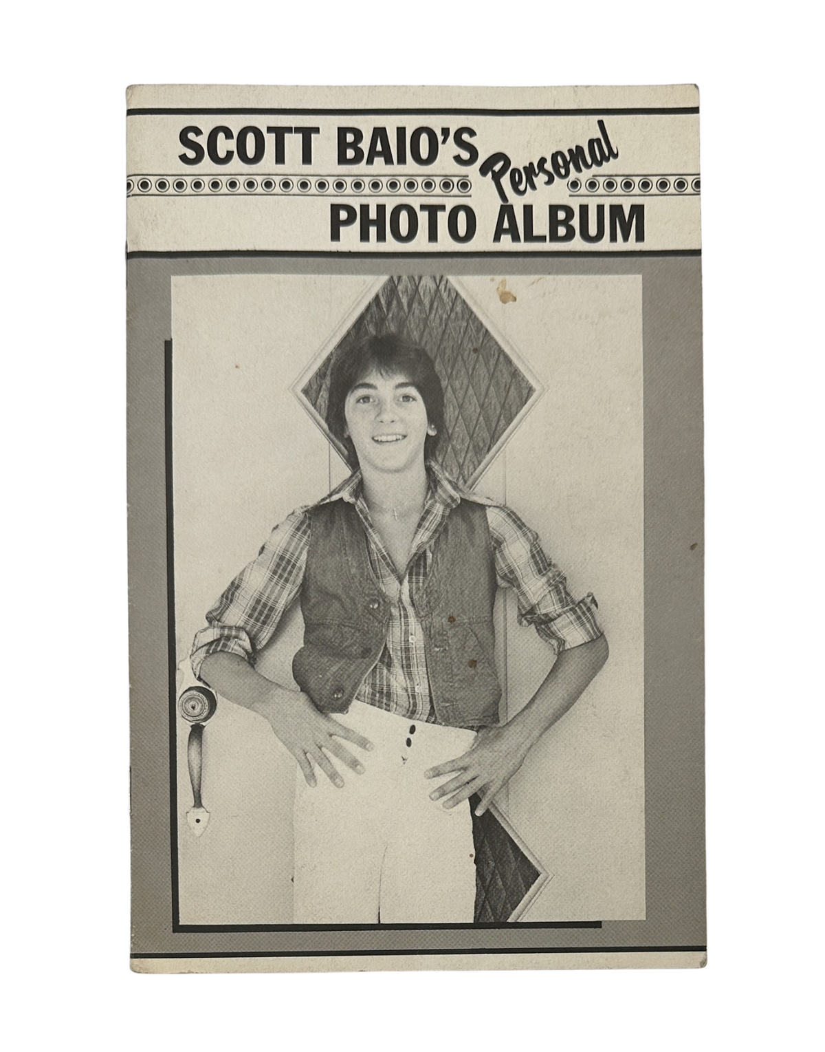 Cover of Scott Baio’s Personal Photo Album magazine, showcasing a vintage black and white photo of a young Scott Baio in a vest and stylish pants, reflecting his status as a 1970s teen idol from Happy Days.