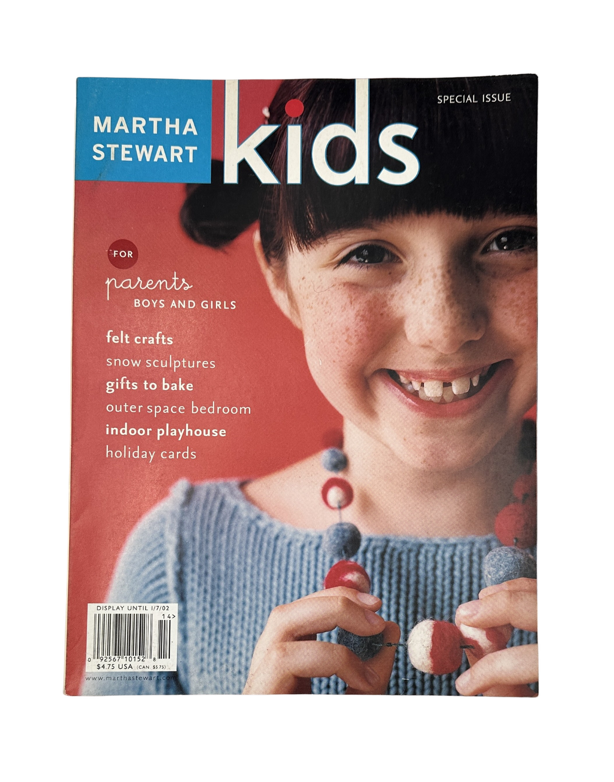 Martha Stewart Kids Magazine Holiday 2001 cover featuring a smiling child with a colorful bead necklace, emphasizing crafts, baking, holiday cards, and indoor playhouse ideas.