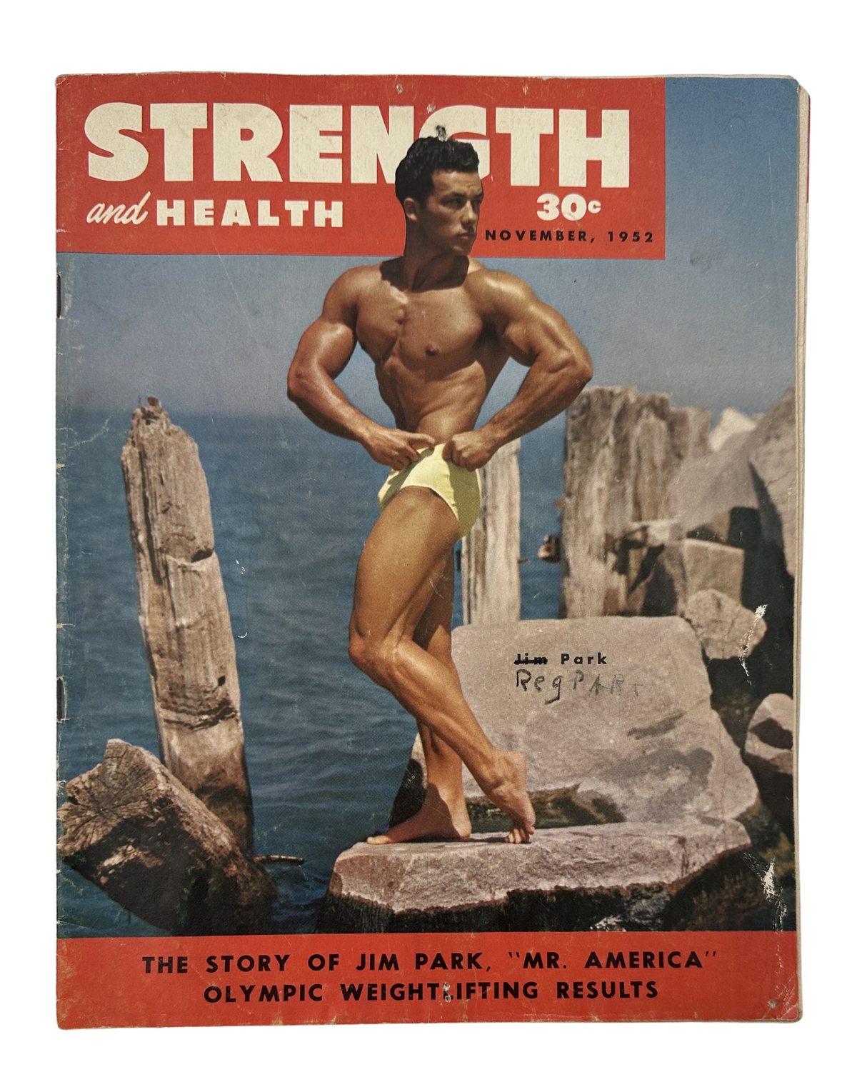 Strength and Health Magazine cover from November 1952 featuring Jim Park, Mr. America, showcasing his physique on the beach with a yellow swimsuit.