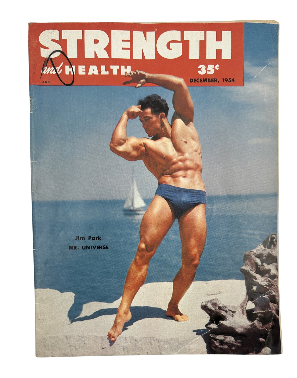 Strength and Health Magazine December 1954 cover featuring Jim Park, Mr. Universe, posing flexibly by the water.