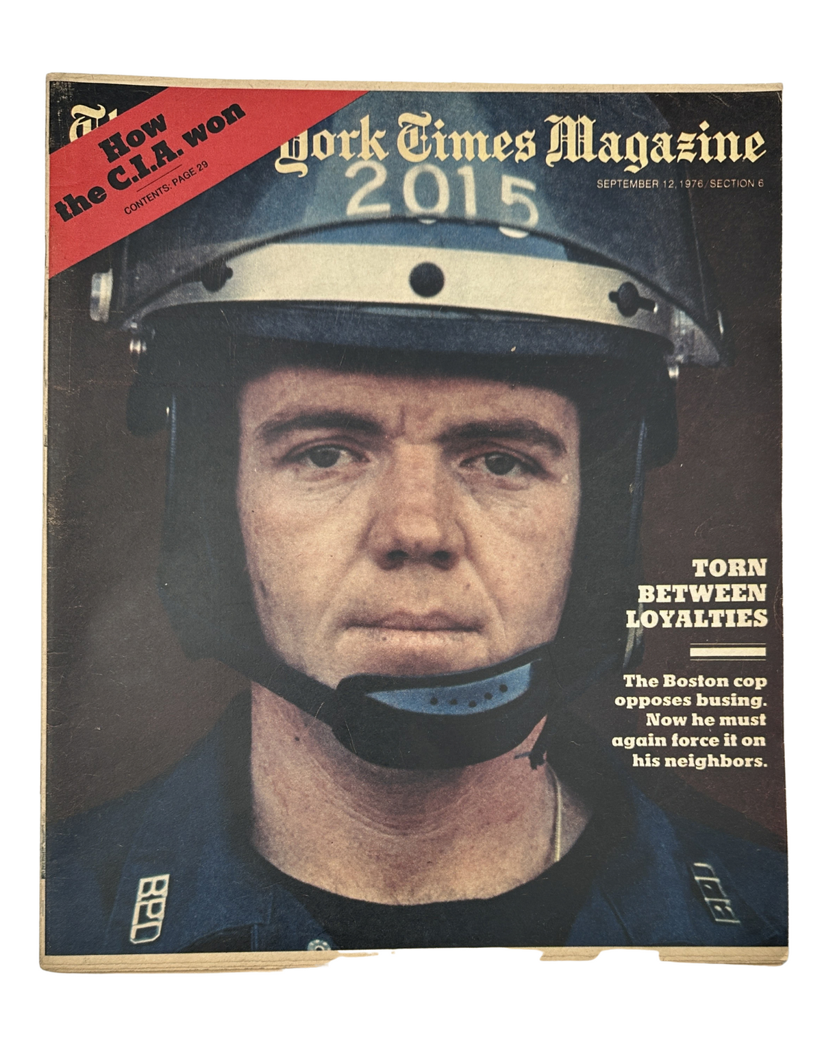 Cover of The New York Times Magazine from September 12, 1976, featuring a Boston police officer wearing a helmet, depicting the theme 'Torn Between Loyalties' related to the busing crisis.