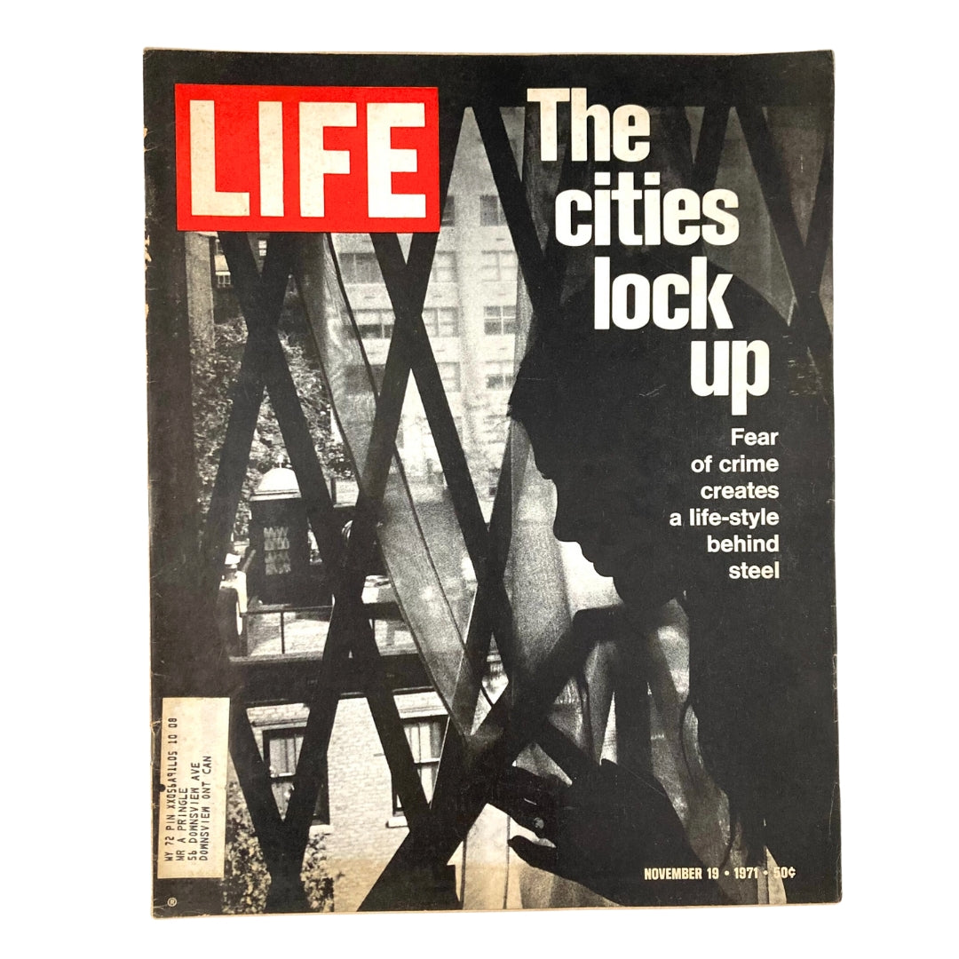 Cover of VTG Life Magazine November 19, 1971, Vol 71 No. 21 titled 'The Cities Lock Up', featuring a silhouette behind security bars with a backdrop of urban scenery, exploring themes of crime and safety in cities.